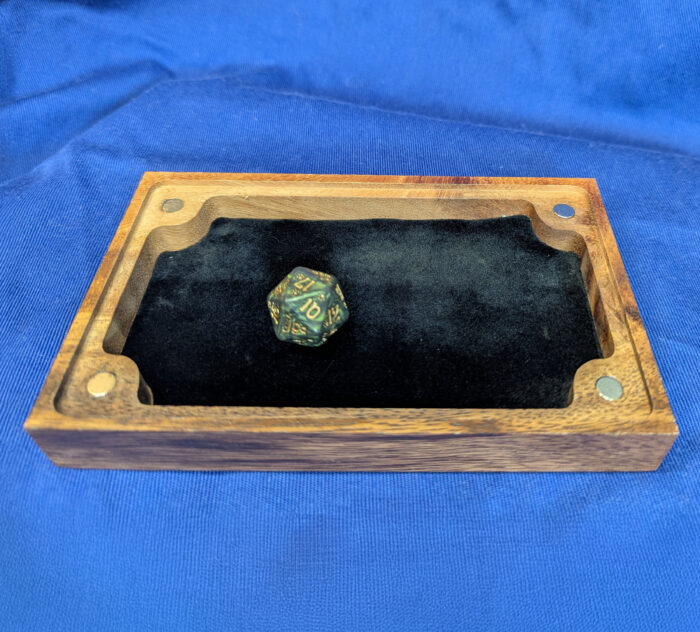 A 20 sided die in a dice tray
